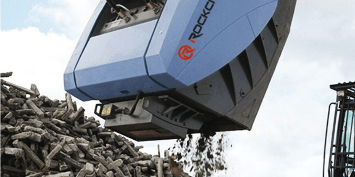 A rockcrusher attachment grinds down concrete debris turning it into reusable material